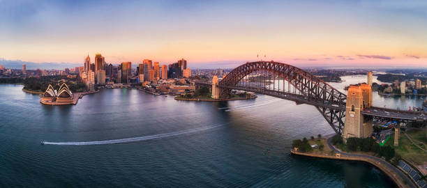 Side view of Sydney Harbour bridge in bright blue sky.